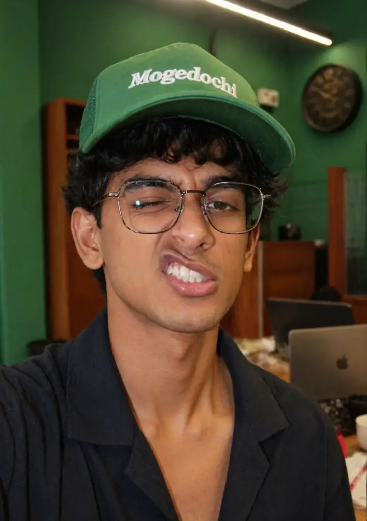 Weird lip expression Man with Mogedochi Creative agency green hat